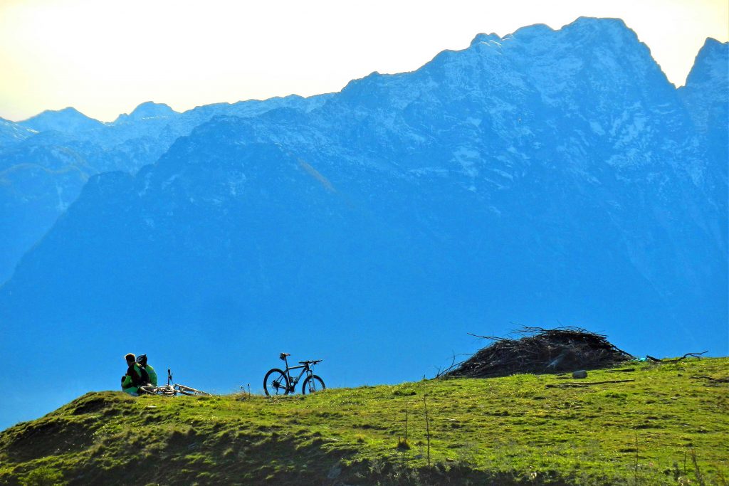 Mountainbike---Rast-mit-Ausblick-auf-schneebedeckte-Berge